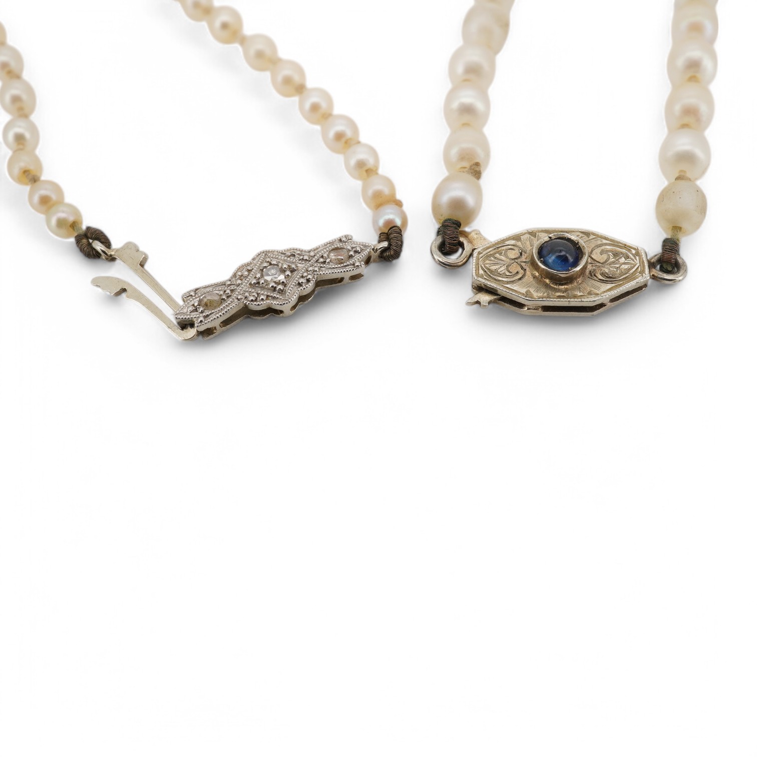 Two single strand cultured pearl necklaces, one graduated with 18ct, plat and three stone diamond set clasp, 60cm, the other with cabochon sapphire set unmarked clasp (a.f.). Condition - poor to fair.